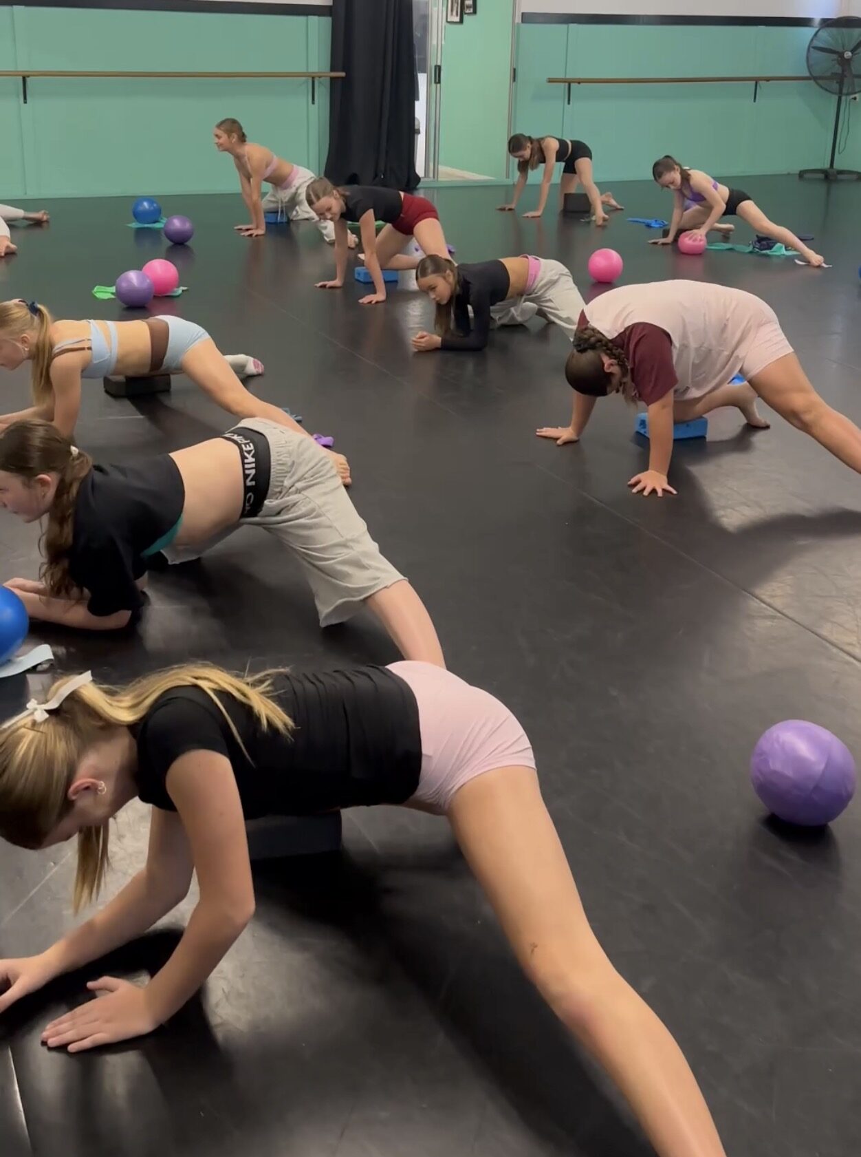 Dancers in a plank series during conditioning
